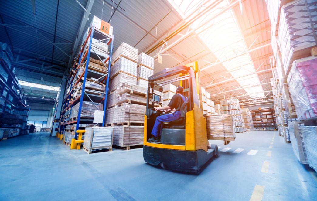 Man operating a forklift in a commercial warehouse